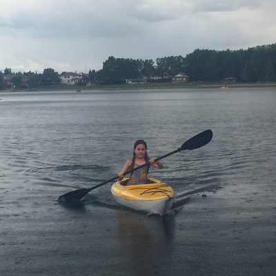 Girl kayaking in the rain